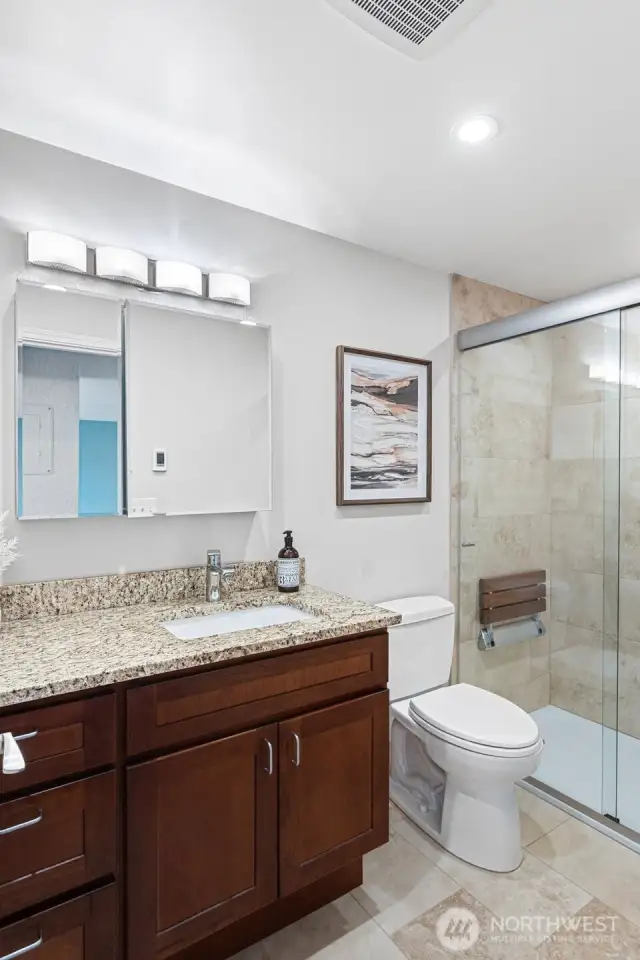 Updated Bathroom: Granite vanity, Toto toilet, large walk-in shower with tile surround,  hand-held shower, shampoo niche and flip-down shower seat, grab bar, heated floors, Delta quiet exhaust fan with humidity censor