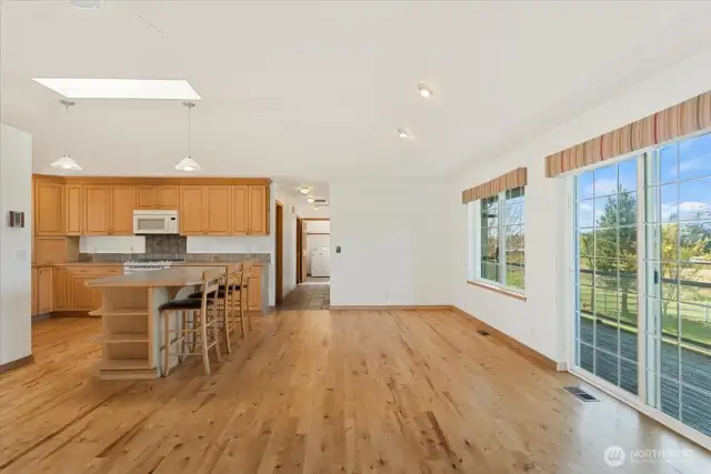 Living space open to kitchen, island & bar seating. Access to deck off this space.