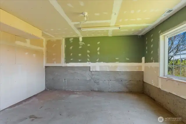 Unfinished space on lower level, possible gym or hobby room - access to backyard as well from this space.