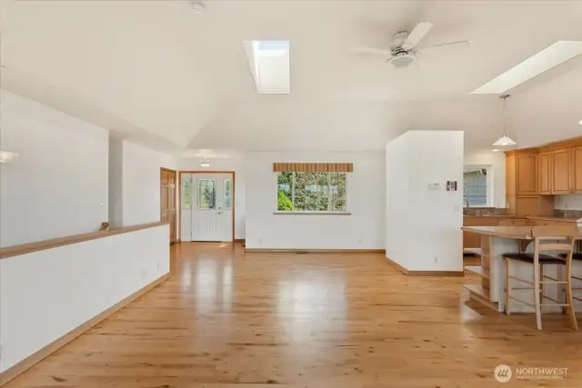 Spacious main living space, open to kitchen, island that accommodates bar stools.