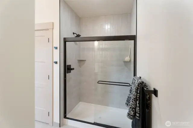 floor to ceiling tiled shower in primary bathroom