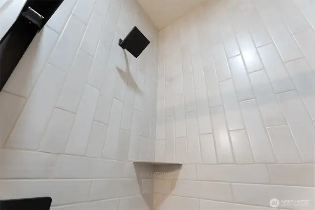 beautiful tiled shower in primary bathroom