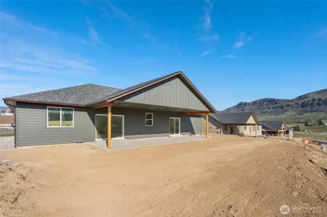 slider from dining room and primary bedroom to wide covered cement patio!
