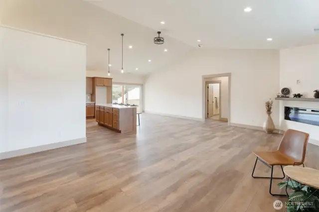 Wide open space, vaulted ceilings, electric fireplace and luxury plank flooring