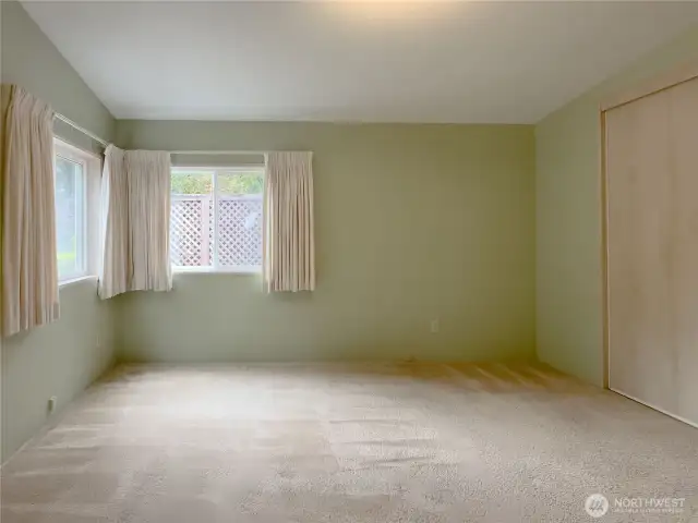 Primary bedroom with vaulted ceilings