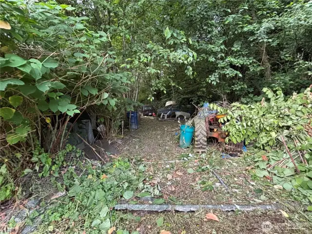 Tractor, pull behind utility trailer, and approximately 6 cars are on the property and shall convey with the sale