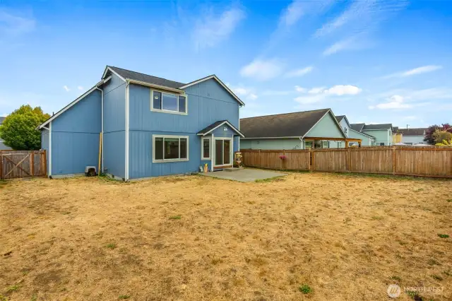 An expansive, fully-fenced backyard awaits your vision!