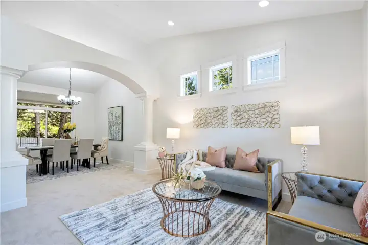Elegant formal living space filled with natural light and windows.