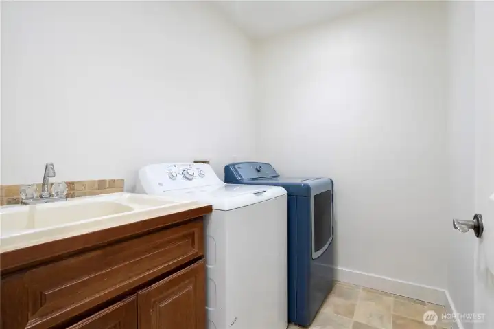 Convenient upper-level laundry with sink.