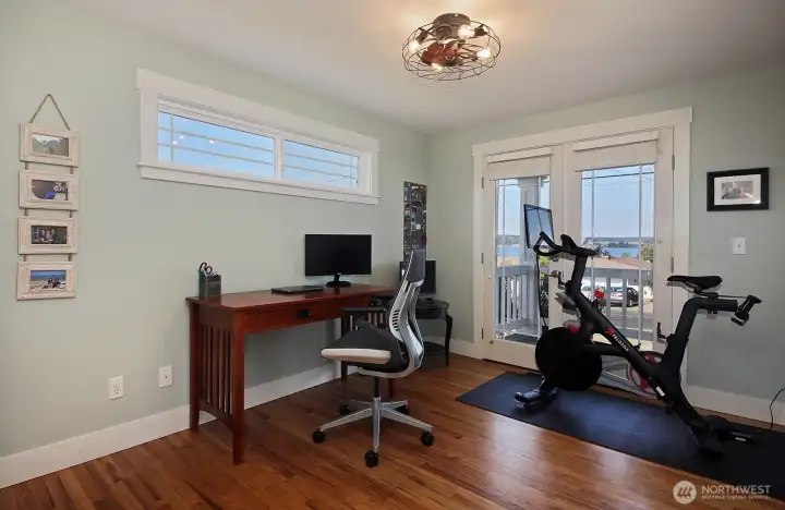 2nd bedroom is used here as a workout space and additional office. Again, lovely view and french doors invite you to enjoy our mild weather and views of Penn Cove.