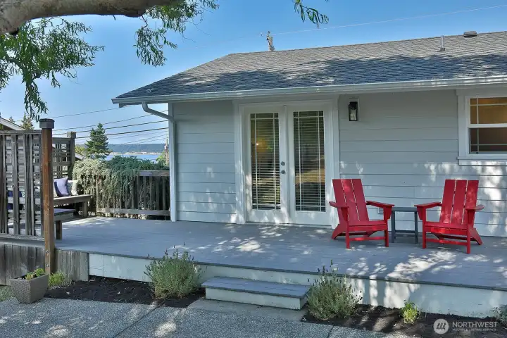 Step out to the back yard with a view of the water from the deck seating area.