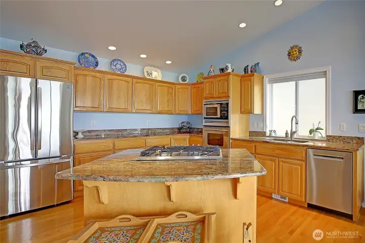 Chefs kitchen featuring big island, granite countertops...