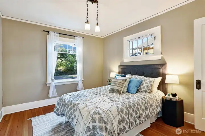 Mullioned windows & beautiful lighting make this bedroom bright & elegant.
