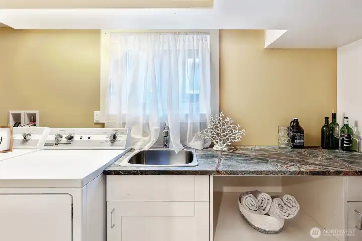 Utility sink & storage cabinets make laundry day a breeze. Laundry space can double as a wet bar for lower level entertaining!