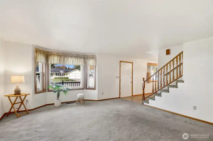 It features a charming bay window that overlooks the front porch.