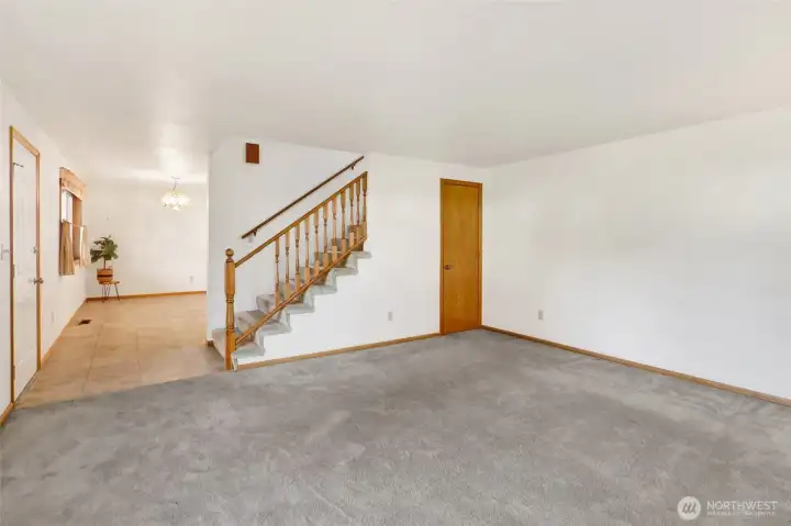 The kitchen and dining room is to the left of the front door.