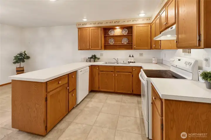 White appliances plus a plate display rack over the sink.