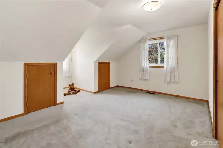 Bedroom 2 with a dormer window and 2 fun little storage doors perfect for "secret forts"