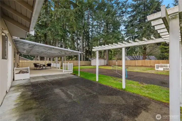 Huge covered vinyl deck, huge patio area plus a pickle ball court!