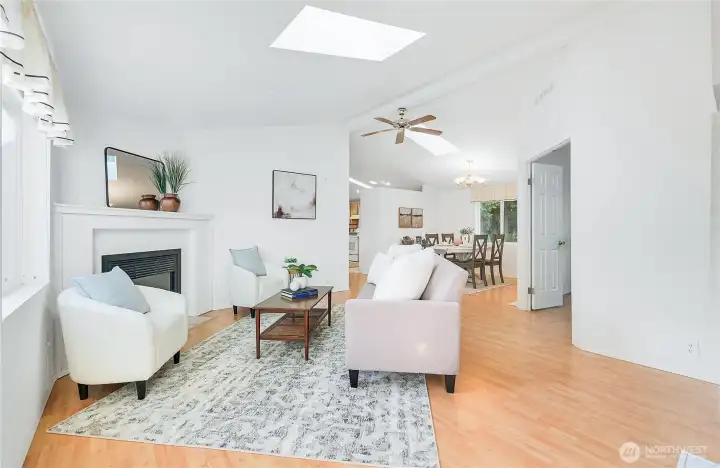 Entry with coat closet to the right of frame, living room opens to the dining area, with a doorway leading to the office.