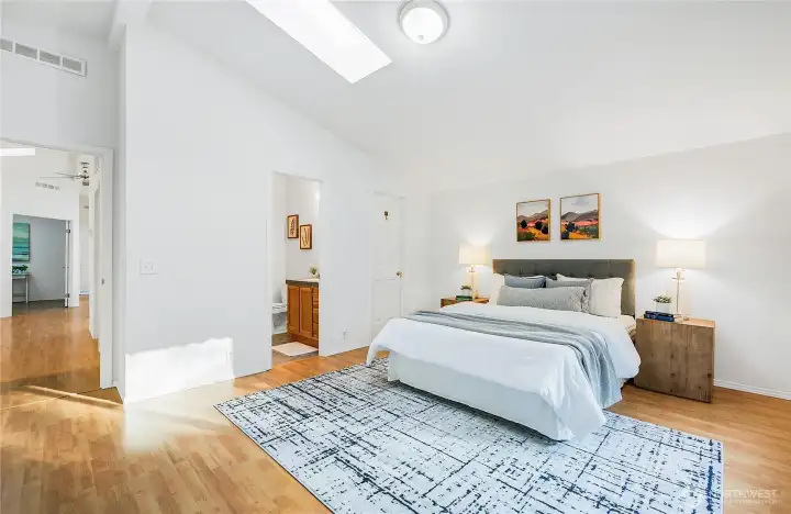 Living area to spacious primary bedroom w/ 3/4 bath and walk-in closet.