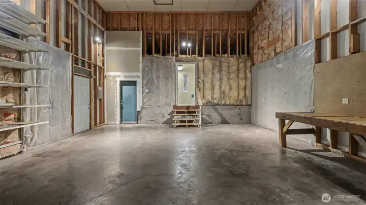 Double-height attached 24' wide x 28' deep garage with 10' garage door and alley access.