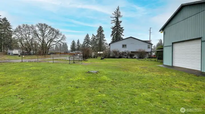 Large level backyard with alley access to double height garage with 10' garage door