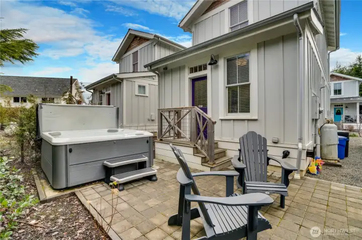 Out back, enjoy a private patio complete with a hot tub—fully included with the home.