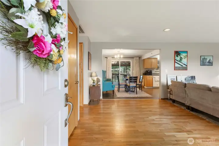 Front door opens to beautiful hardwood floors in the living room and hallway.