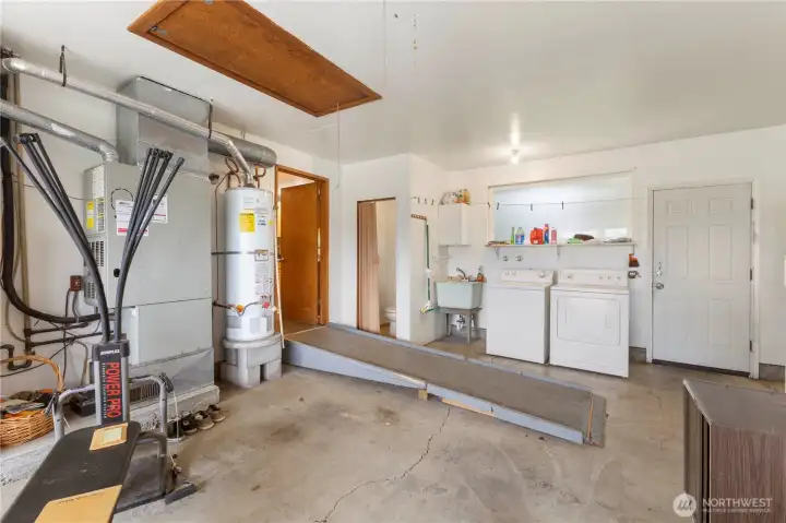 Ramp from garage to kitchen. Half bath and laundry are located in the garage. Utility sink makes it easy to clean up after working in the yard.