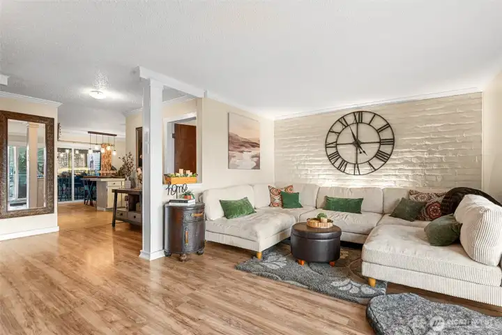 Large living room area with brick accents