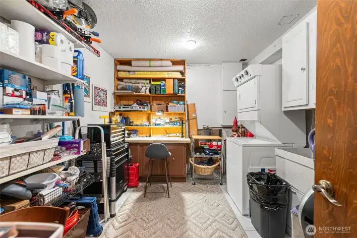 Laundry room with built-in shelves, shop/craft area