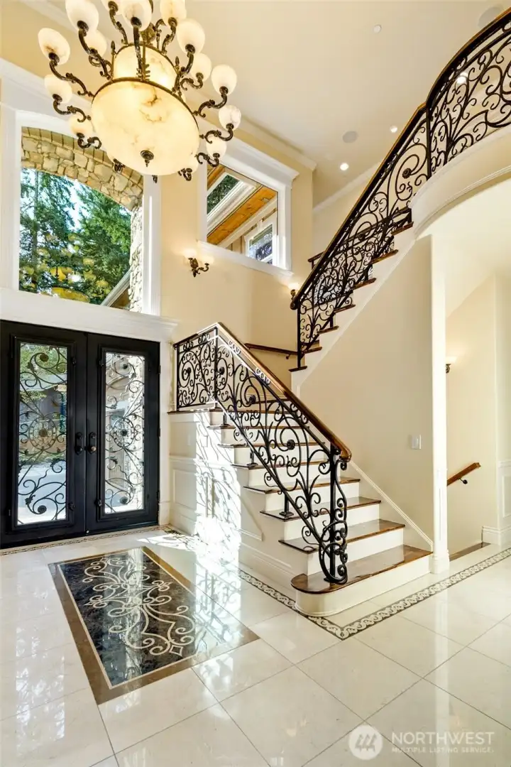 Intricate Iron and glass doors with designer iron baluster staircase