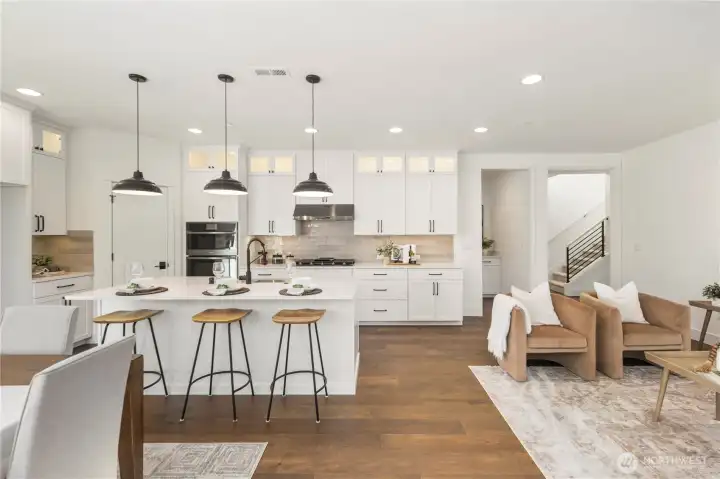 Kitchen:  This bright kitchen features white cabinetry, quartz countertops, a statement island with a farmhouse sink, and oversized pendant lighting that adds depth and visual balance. Its open layout supports cooking, gathering, and effortless movement between the main living areas. Positioned in Bothell’s Canyon Park neighborhood, the space benefits from proximity to local shopping, parks, and commuter routes, making daily routines streamlined and connected. Modern finishes, warm wood flooring, and thoughtful storage create a kitchen designed for both everyday ease and elevated hosting.    These photos are from Lot 5 at Gooden Hollow, the community model. The home listed will have changes, so all photos, renderings, site maps, and floorplans are for visualization purposes only. Plans, colors, building orientation, finishes, home outlook, and other details can and WILL vary.