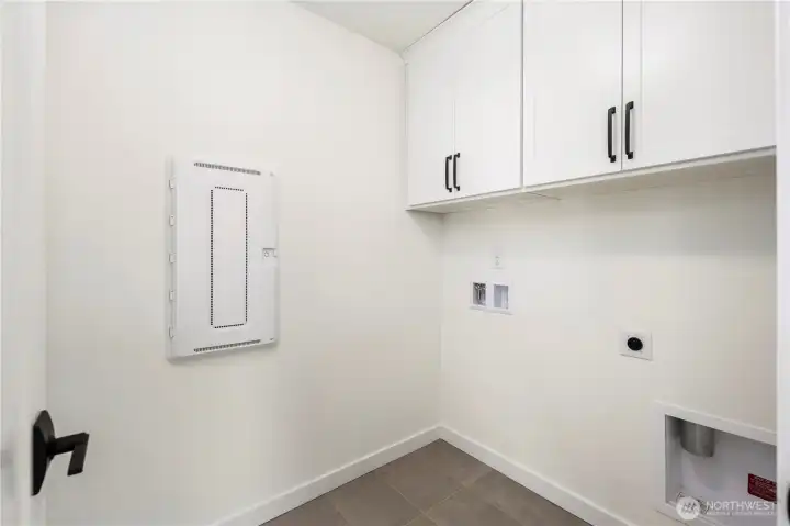 Laundry Room (Washer/Dryer Wall):  This dedicated laundry area includes upper cabinetry for organized storage and durable tile flooring designed for everyday function. Its location on the upper level keeps daily routines easy and efficient. With quick access to both Canyon Park conveniences and major Eastside routes, household tasks feel streamlined and integrated into daily living. The neutral palette and clean lines make it simple to pair with your preferred appliances and organizational systems.    These photos are from Lot 5 at Gooden Hollow, the community model. The home listed will have changes, so all photos, renderings, site maps, and floorplans are for visualization purposes only. Plans, colors, building orientation, finishes, home outlook, and other details can and WILL vary.