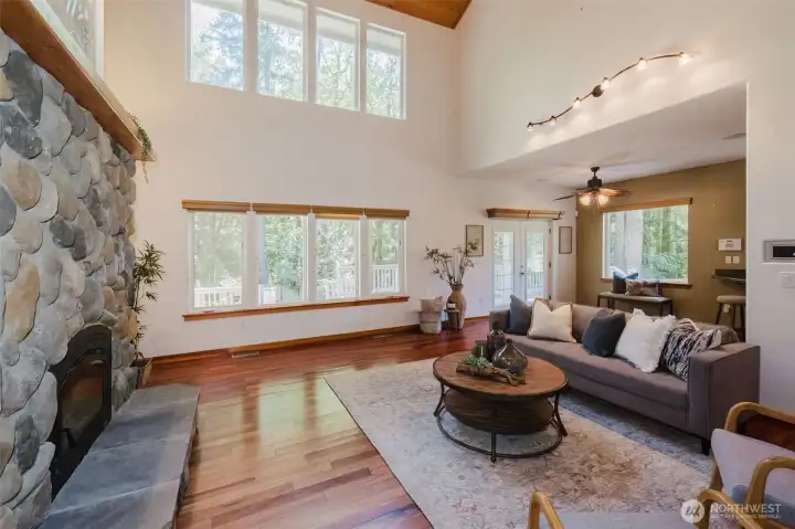 Living room has double height ceilings and wall of windows