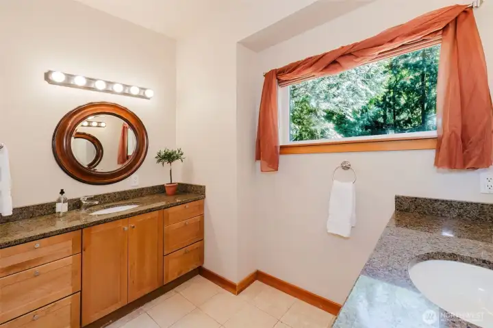 Primary ensuite with double sinks, stone shower