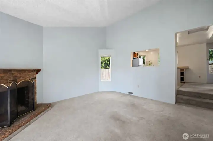 Vaulted ceilings and wood burning fireplace make this home inviting.