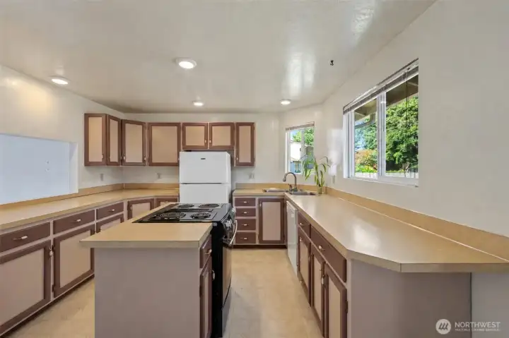 Functionally designed kitchen with viewing window to living room. (completed cabinets virtually rendered)