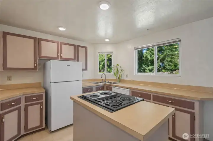 Unique design with range in the island allows for cooking & entertaining seamlessly! (completed cabinets virtually rendered)