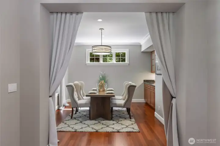 Formal dining space with buffet area and wetbar area.