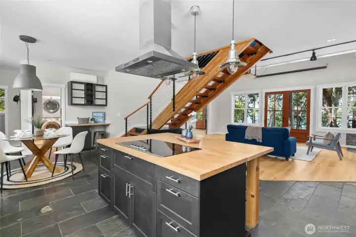 Slate floors frame the kitchen island that includes a handy breakfast bar. Slate floors frame the kitchen island that includes a handy breakfast bar.