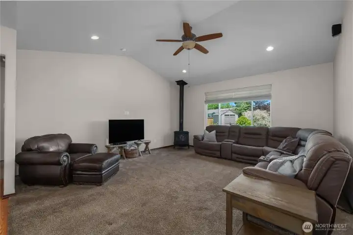 Large livingroom with ceiling fan and view of your beautifully landscaped backyard.