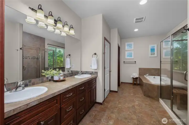 5 piece primary ensuite with large linen/storage closet, double sink vanity, walk-in shower, soaking tub and direct access to the walk-in closet.