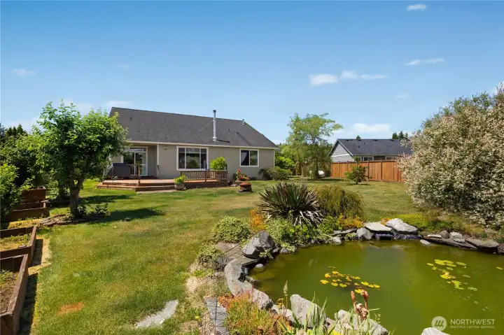 Back yard features mature landscaping, fruit trees and 4 raised garden beds.