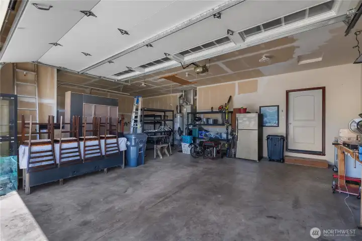 2 car bay with wood work bench, and features additional storage above with easy access pull down steps.