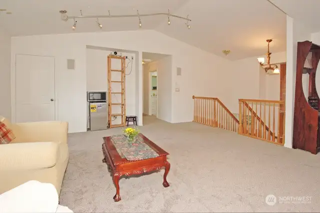 Huge bonus room leads back into the primary bedroom on the top level