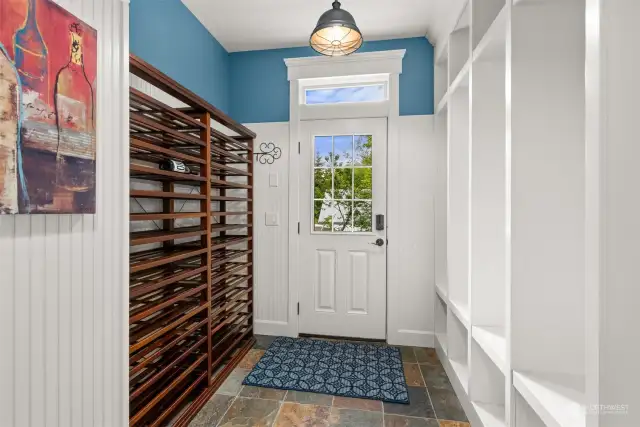 Fabulous mud room with convenient storage cabinets and built in wine rack.
