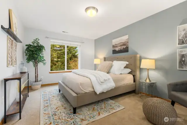 Spacious bedroom at top of stairs.