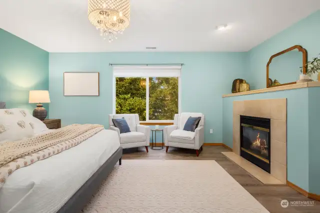 Gas fireplace, crystal chandelier overlooks backyard greens.